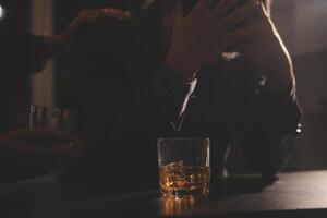 Celebration night, pour whiskey into a glass. Give to friends who come to celebrate photo