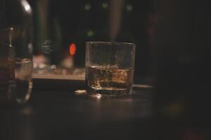 Celebration night, pour whiskey into a glass. Give to friends who come to celebrate photo