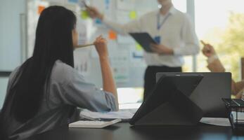 Business team collaboration discussing working analyzing with financial data and marketing growth report graph in team, presentation and brainstorming to strategy planning making profit of company. photo