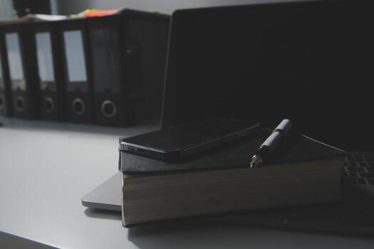 Office workplace with text space, White wooden table with office supplies tablet, desktop computer and book, top view, over light photo