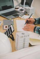 Wind energy engineer designing and developing project for residential district photo
