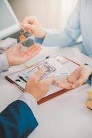 Real estate agent talked about the terms of the home purchase agreement and asked the customer to sign the documents to make the contract legally, Home sales and home insurance concept. photo
