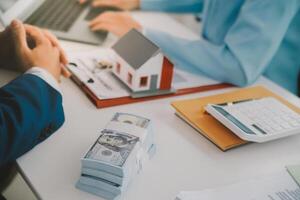 Real estate agent talked about the terms of the home purchase agreement and asked the customer to sign the documents to make the contract legally, Home sales and home insurance concept. photo
