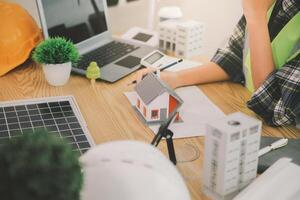 Wind energy engineer designing and developing project for residential district photo