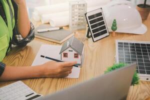 Wind energy engineer designing and developing project for residential district photo