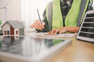 Wind energy engineer designing and developing project for residential district photo