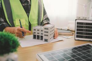 Wind energy engineer designing and developing project for residential district photo