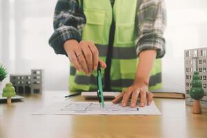 Wind energy engineer designing and developing project for residential district photo