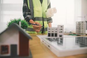 Wind energy engineer designing and developing project for residential district photo