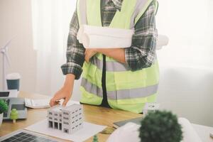 Wind energy engineer designing and developing project for residential district photo