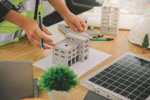 Wind energy engineer designing and developing project for residential district photo