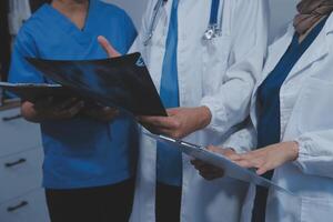 Quality healthcare is all about putting the patient at the centre. Shot of a group of medical practitioners having a discussion in a hospital. photo