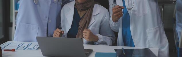 Doctors shaking hands, working together as a team at the hospital. photo