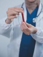 Technician, doctor, scientist in laboratory with blood sample tubes and rack In the laboratory holding a blood vessel sample for study, experiment, medical research biotechnology DNA testing. photo