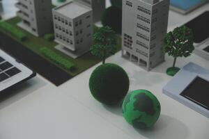 Business people having consultation about wind energy at company office. Business team discussing about windmill and alternative green energy. Executive meeting at modern office photo