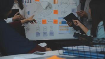 Financial analysts analyze business financial reports on a digital tablet planning investment project during a discussion at a meeting of corporate showing the results of their successful teamwork. photo