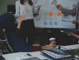 Financial analysts analyze business financial reports on a digital tablet planning investment project during a discussion at a meeting of corporate showing the results of their successful teamwork. photo