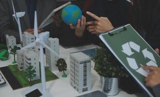Business people having consultation about wind energy at company office. Business team discussing about windmill and alternative green energy. Executive meeting at modern office photo