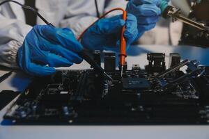 Close up of Technician measuring voltage electronic circuit board television, Service after sale fix electric equipment within insurance. photo