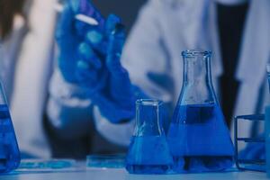 chemist,scientist hand dropping chemical liquid into test tube, science research and development concept photo