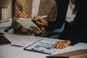 Team of business people working together in the meeting room office, teamwork background charts and graphs banner, double exposure successful teamwork,business planning concept. photo