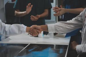 Doctor handshake and partnership in healthcare, medicine or trust for collaboration, unity or support.Team of medical experts shaking hands in teamwork for or success in hospital photo