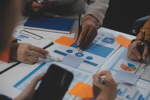 Business team collaboration discussing working analyzing with financial data and marketing growth report graph in team, presentation and brainstorming to strategy planning making profit of company. photo
