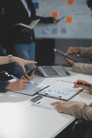 Business team collaboration discussing working analyzing with financial data and marketing growth report graph in team, presentation and brainstorming to strategy planning making profit of company. photo