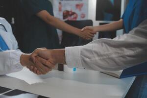 Doctor handshake and partnership in healthcare, medicine or trust for collaboration, unity or support.Team of medical experts shaking hands in teamwork for or success in hospital photo