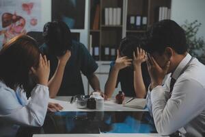 Manager Man Checking Pie Chart Data of Monthly Audit Report and Give a Negative News to his Medical Team in Hospital Boardroom Office or Healthcare Centre Meeting Room photo