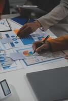 Business team collaboration discussing working analyzing with financial data and marketing growth report graph in team, presentation and brainstorming to strategy planning making profit of company. photo