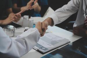 Doctor handshake and partnership in healthcare, medicine or trust for collaboration, unity or support.Team of medical experts shaking hands in teamwork for or success in hospital photo