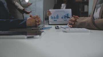 Business team collaboration discussing working analyzing with financial data and marketing growth report graph in team, presentation and brainstorming to strategy planning making profit of company. photo