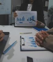 Business team collaboration discussing working analyzing with financial data and marketing growth report graph in team, presentation and brainstorming to strategy planning making profit of company. photo