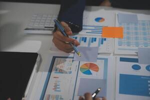 Business team collaboration discussing working analyzing with financial data and marketing growth report graph in team, presentation and brainstorming to strategy planning making profit of company. photo