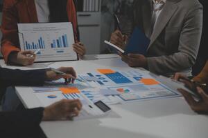 Business team collaboration discussing working analyzing with financial data and marketing growth report graph in team, presentation and brainstorming to strategy planning making profit of company. photo