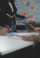 Business team collaboration discussing working analyzing with financial data and marketing growth report graph in team, presentation and brainstorming to strategy planning making profit of company. photo