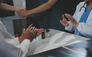 Doctor handshake and partnership in healthcare, medicine or trust for collaboration, unity or support.Team of medical experts shaking hands in teamwork for or success in hospital photo