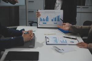 Business team collaboration discussing working analyzing with financial data and marketing growth report graph in team, presentation and brainstorming to strategy planning making profit of company. photo
