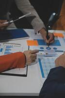 Business team collaboration discussing working analyzing with financial data and marketing growth report graph in team, presentation and brainstorming to strategy planning making profit of company. photo