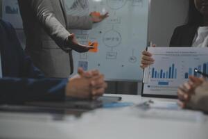 Business team collaboration discussing working analyzing with financial data and marketing growth report graph in team, presentation and brainstorming to strategy planning making profit of company. photo
