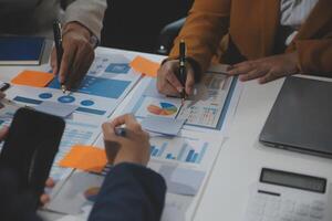 Business team collaboration discussing working analyzing with financial data and marketing growth report graph in team, presentation and brainstorming to strategy planning making profit of company. photo