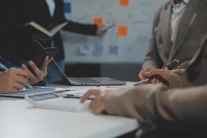 Business team collaboration discussing working analyzing with financial data and marketing growth report graph in team, presentation and brainstorming to strategy planning making profit of company. photo