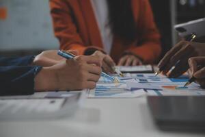 Business team collaboration discussing working analyzing with financial data and marketing growth report graph in team, presentation and brainstorming to strategy planning making profit of company. photo