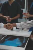 Doctor handshake and partnership in healthcare, medicine or trust for collaboration, unity or support.Team of medical experts shaking hands in teamwork for or success in hospital photo