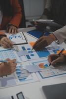 Business team collaboration discussing working analyzing with financial data and marketing growth report graph in team, presentation and brainstorming to strategy planning making profit of company. photo