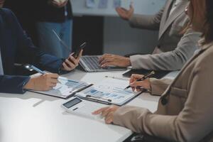 Business team collaboration discussing working analyzing with financial data and marketing growth report graph in team, presentation and brainstorming to strategy planning making profit of company. photo