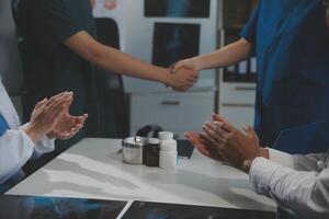 Doctor handshake and partnership in healthcare, medicine or trust for collaboration, unity or support.Team of medical experts shaking hands in teamwork for or success in hospital photo