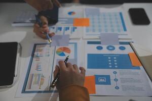 Business team collaboration discussing working analyzing with financial data and marketing growth report graph in team, presentation and brainstorming to strategy planning making profit of company. photo