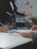 Business team collaboration discussing working analyzing with financial data and marketing growth report graph in team, presentation and brainstorming to strategy planning making profit of company. photo